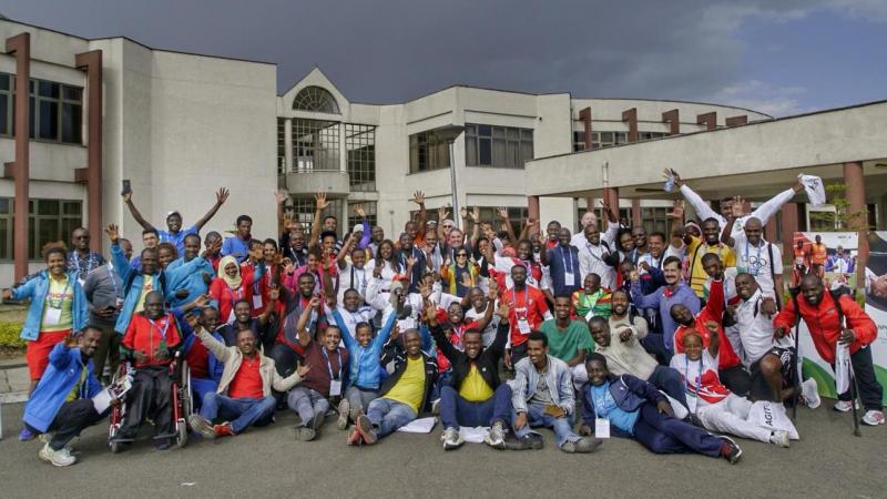 Group of people posing for a picture in front of a building