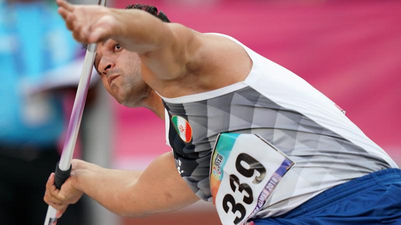 male Para athlete Amanolah Papi prepares to throw a javelin