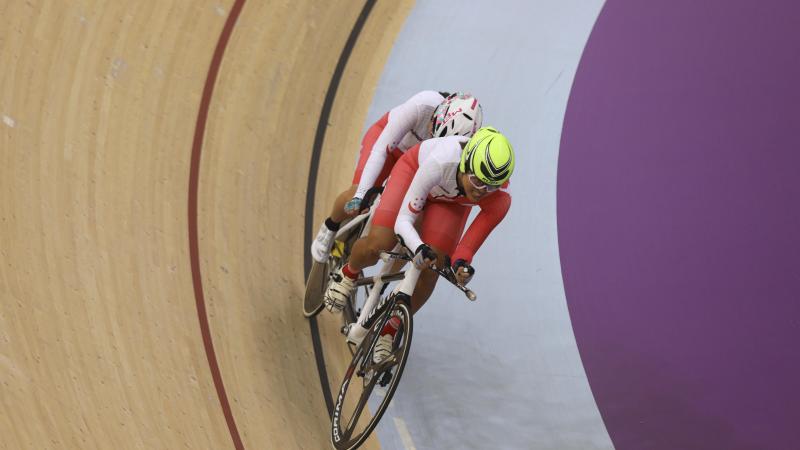 female Para cyclist Emily Lee goes round the track on a tandem cycle