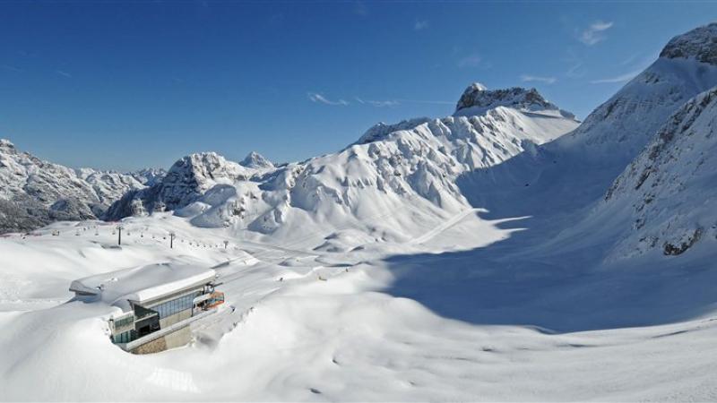 a wide shot of snowy mountains and a chairlift in Sella Nevea