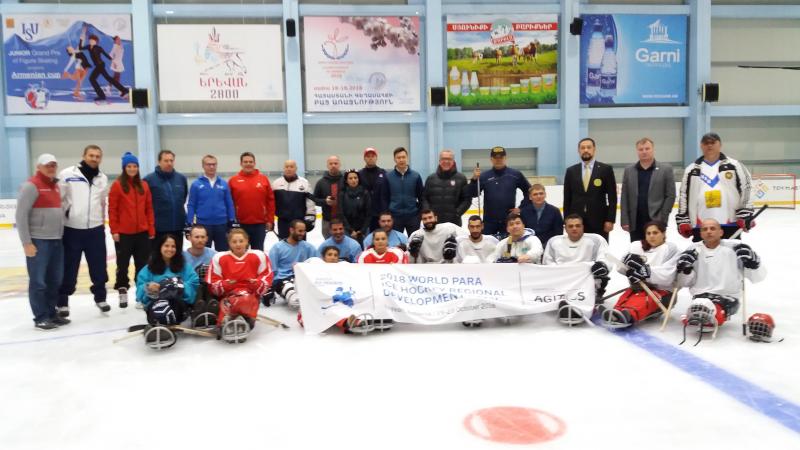 A group of people on sledges on an ice hockey rink