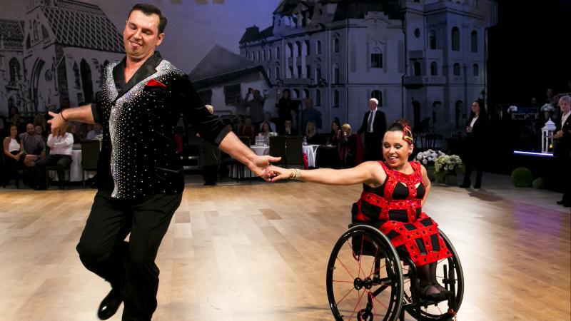 female Para dancer Helena Kasicka holding hands with her male partner during a dance