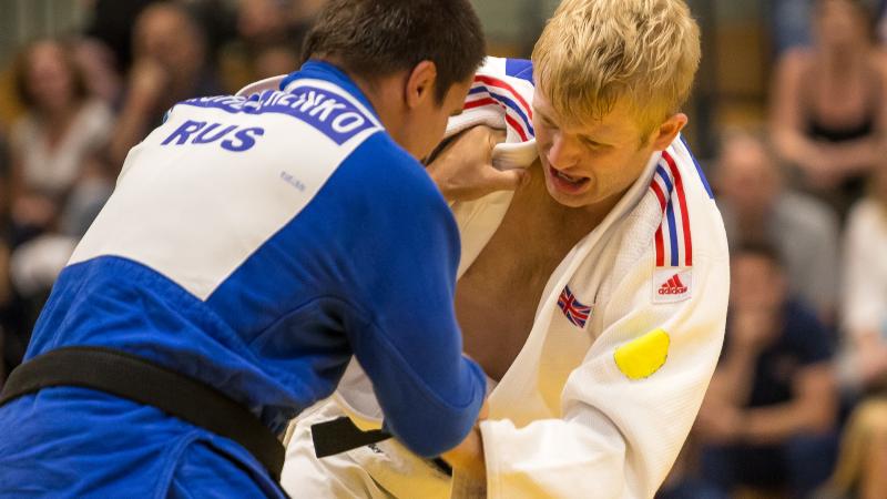 male judoka Chris Skelley wrestles with another fighter 