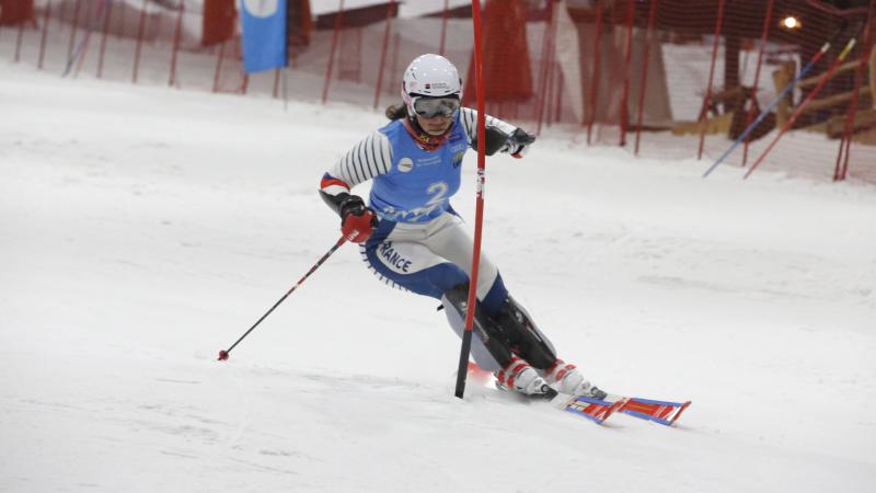 female Para alpine skier Marie Bochet goes round a gate