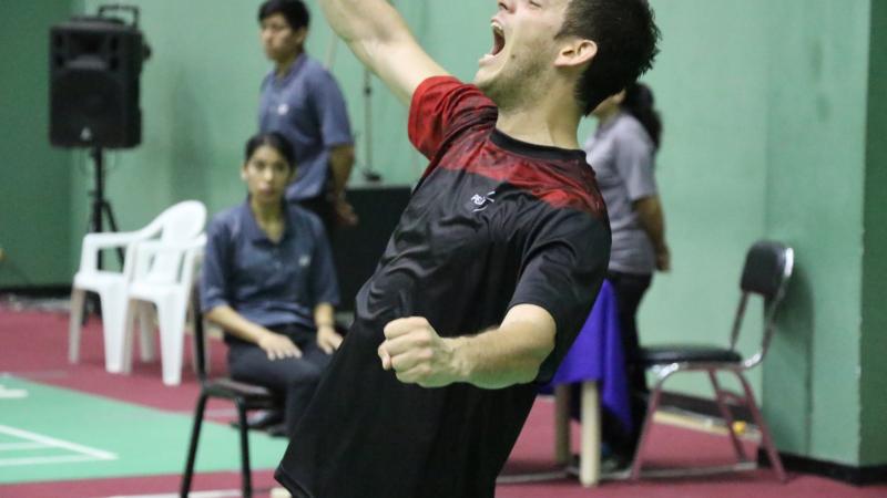 male badminton player Pedro Pablo de Vinatea screams and throws his arms up in celebration