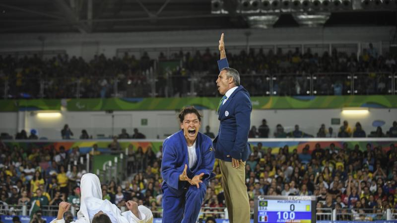 female judoka Lenia Ruvalcaba getting up off her knees and screaming in joy