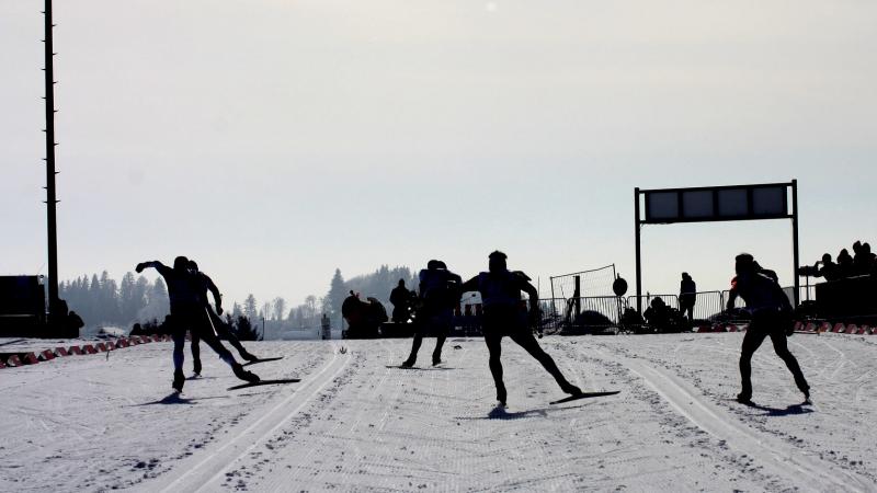 A group of cross-country skiers competing
