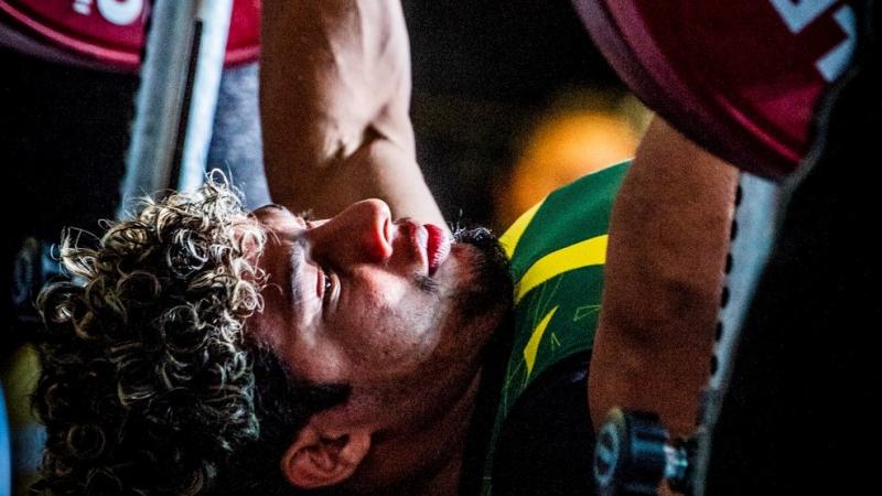 male powerlifter Joao Franca Junior prepares to lift the bar