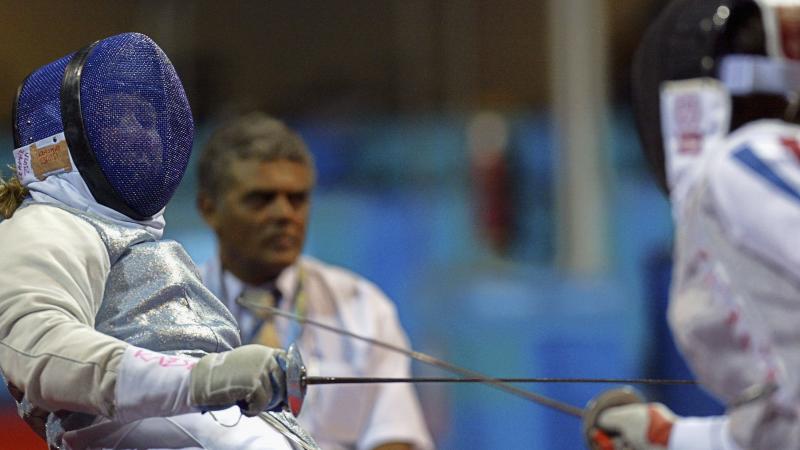 female wheelchair fencer Zsuzsanna Krajnyak dodges away from the foil