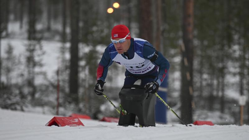 male Para Nordic sit skier Daniel Cnossen pushes through the snow