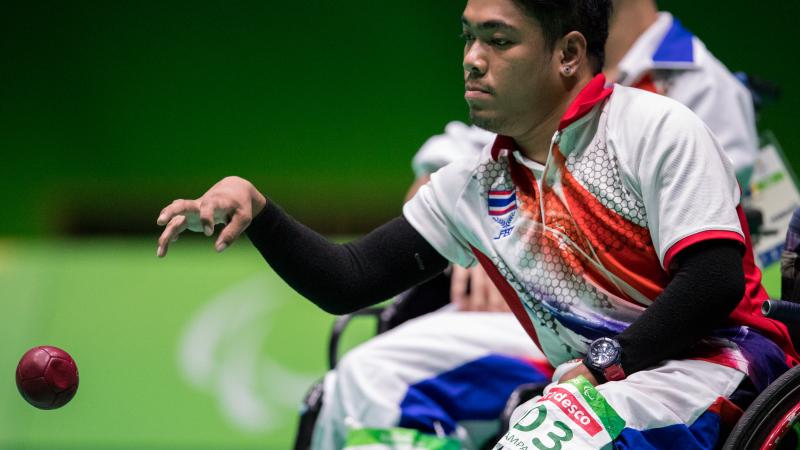 male boccia player Worawut Saengampa plays a ball