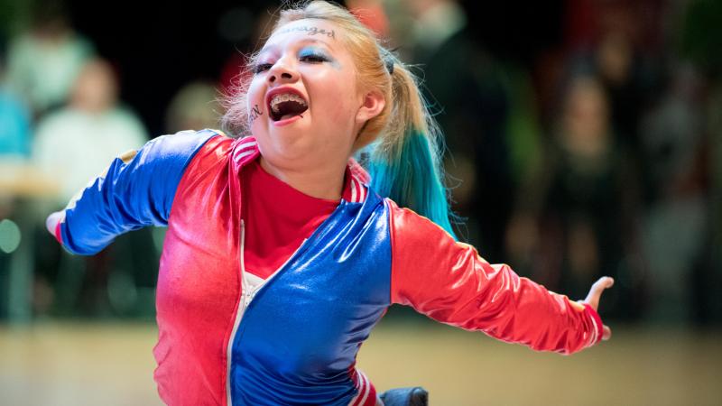 Young Mexican female athlete dances in her wheelchair