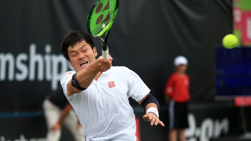 male wheelchair tennis player Shingo Kunieda hits a backhand