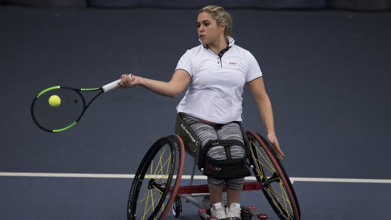 female wheelchair tennis player Giulia Capocci plays a forehand on a hard court