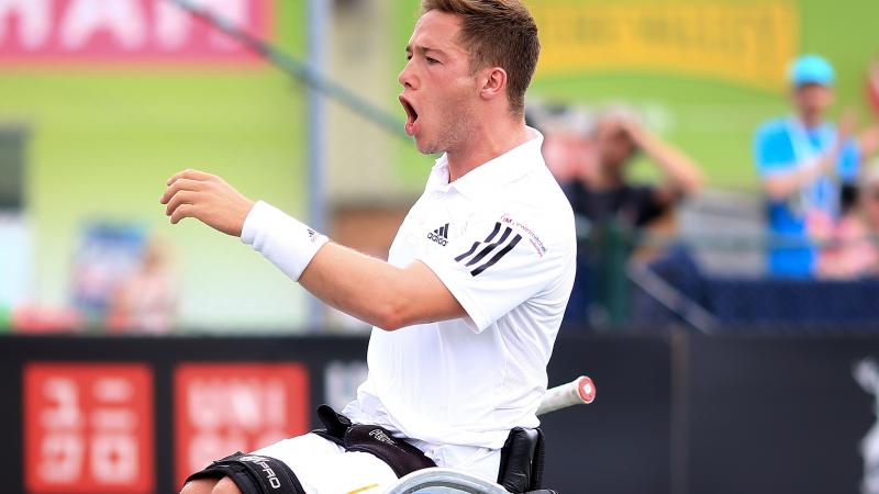 male wheelchair tennis player Alfie Hewett yells in triumph after winning a point