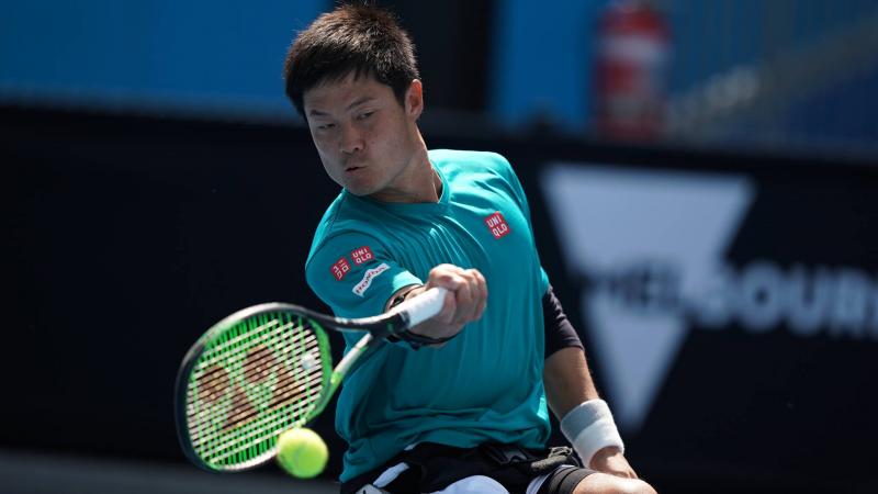 male wheelchair tennis player Shingo Kunieda plays a forehand on a hard court