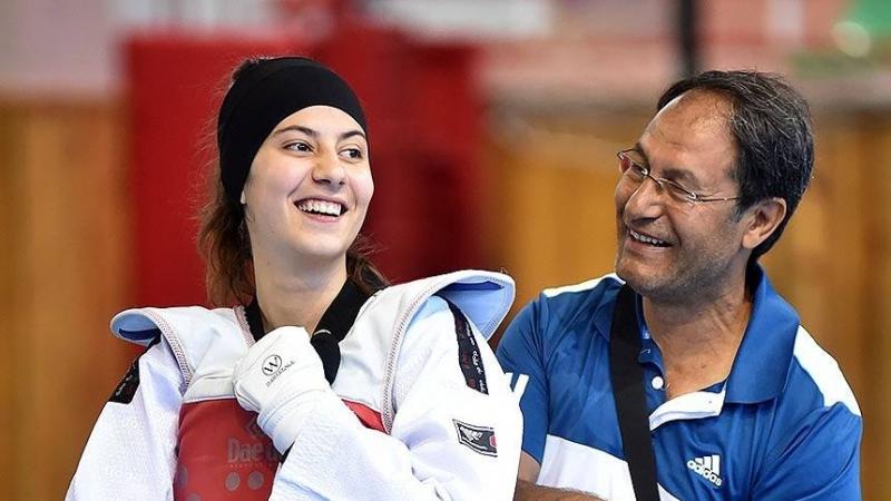 female Para taekwondo fighter Meryem Betul Cavdar smiles with her coach