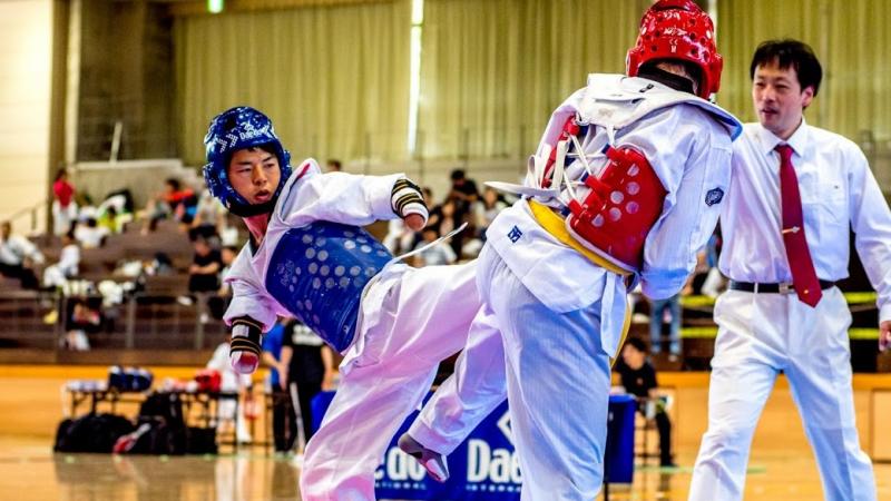 male Para taekwondo fighter Kenta Awatari kicks another fighter 