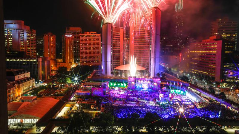 a high shot of fireworks and lasers in central Toronto