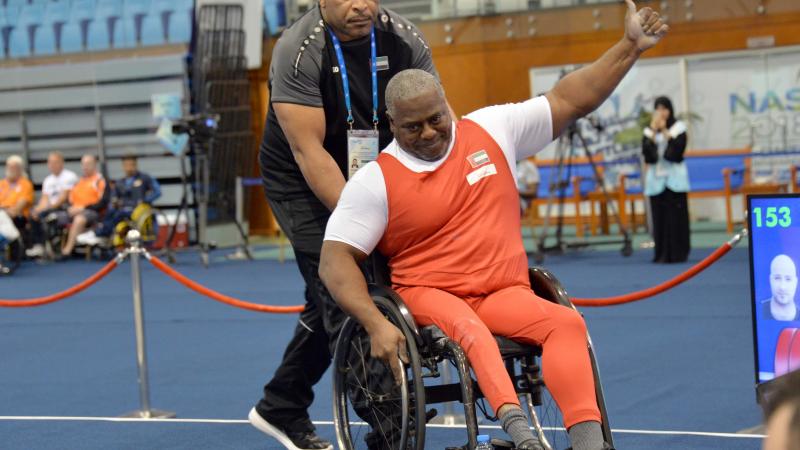 male Para powerlifter Mohammed Khamis Khalaf gives a thumbs up and smiles