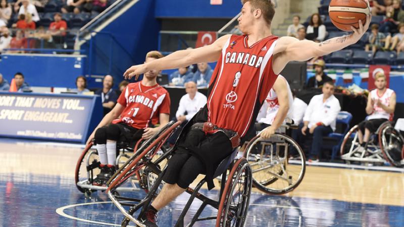 male wheelchair basketballer Liam Hickey tilts sideways as he prepares to throw the ball