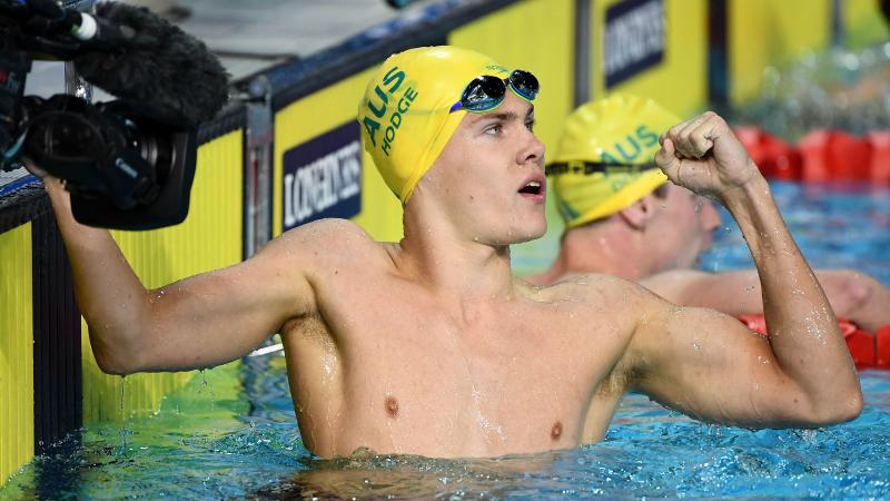 male Para swimmer Timothy Hodge fistpumps after winning a race