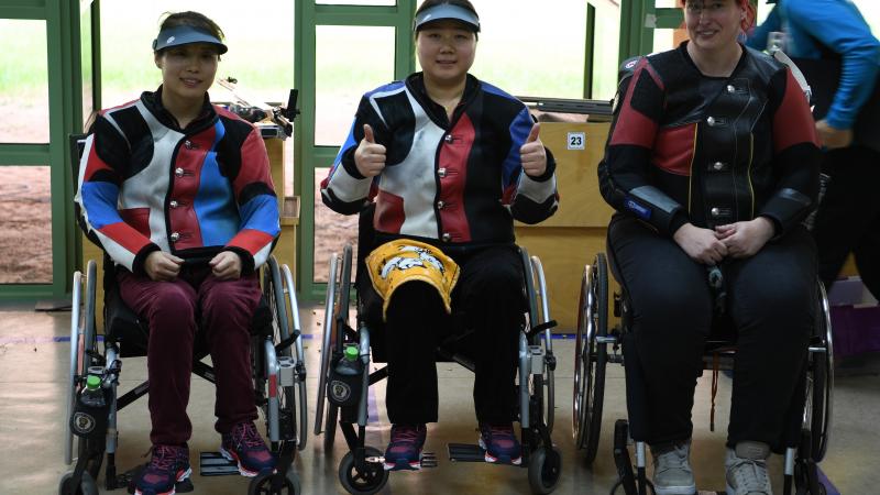 three female Para shooters with Zhang Cuiping giving a thumbs up