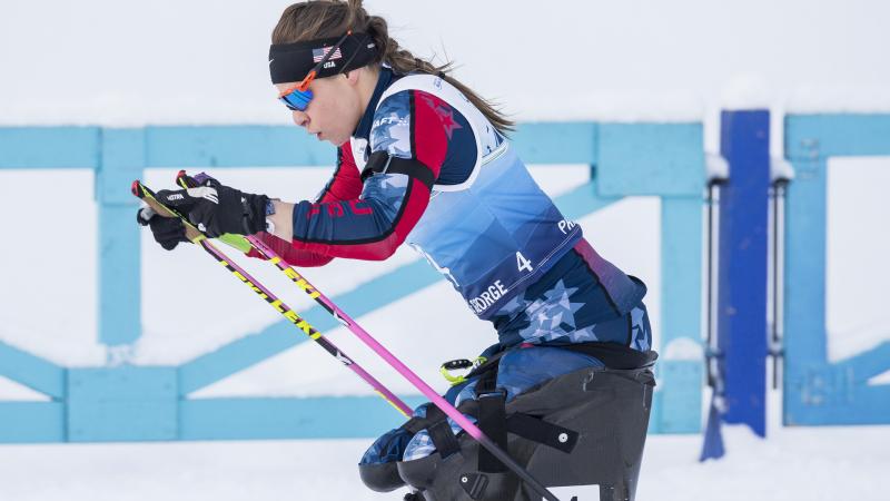 female Para Nordic skier Oksana Masters drives her ski poles through the snow