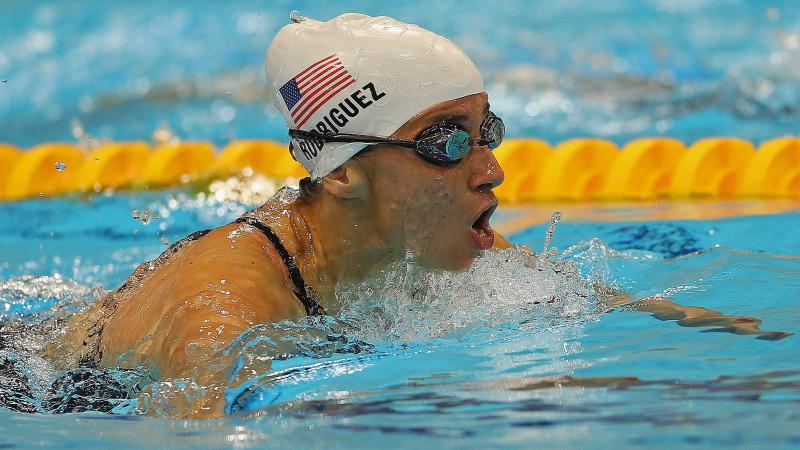 female Para swimmer Ileana Rodriguez takes a breath during a breaststroke