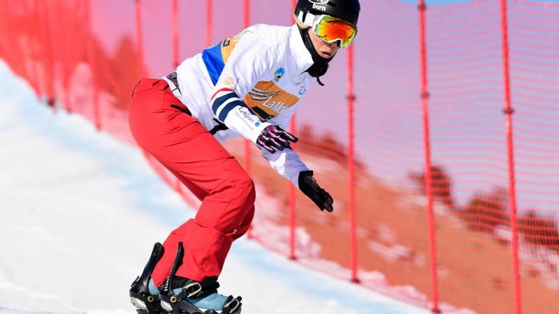 A female Para snowboarder competing