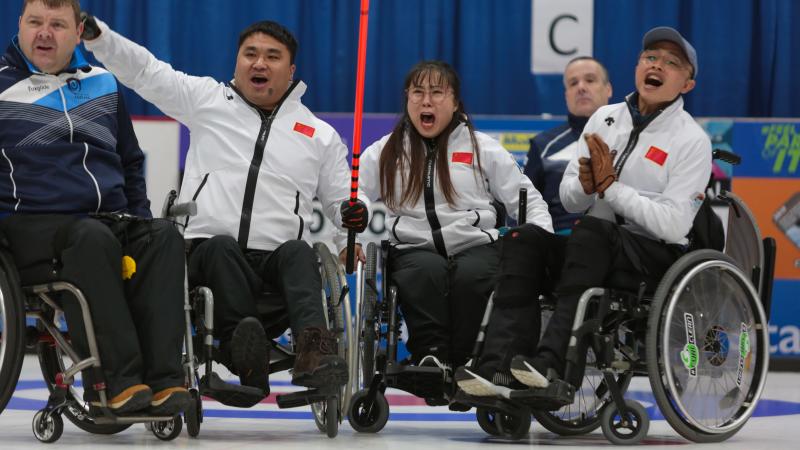 Haitao Wang, Qiang Zhang, Zhou Yan - wheelchair curling - China Three Chinese wheelchair curlers celebrate expressively on the ice