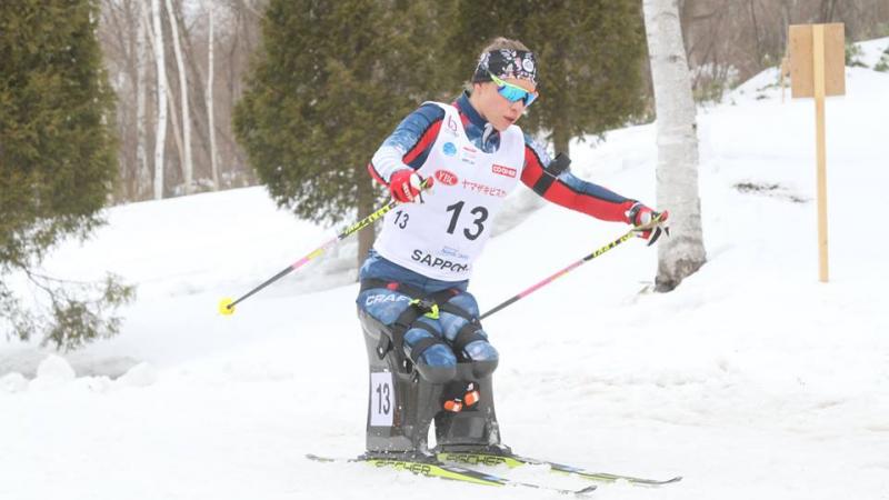 female Para Nordic sit skier Oksana Masters turns round a bend in the course