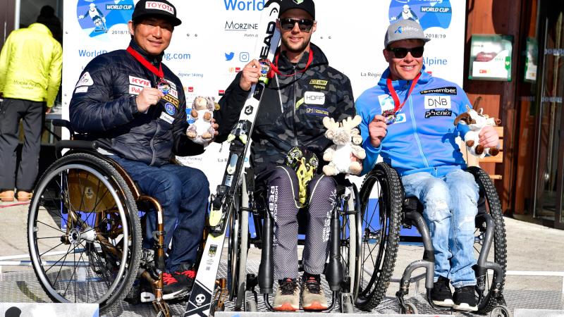 male Para alpine sit skier Igor Sikorski on the podium