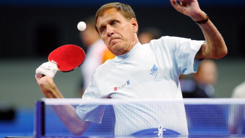 male Para table tennis player Matti Launonen plays a forehand