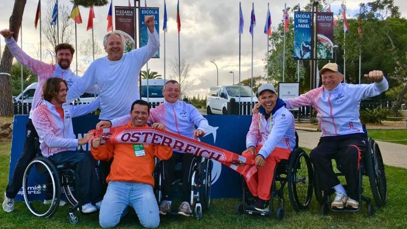 male wheelchair tennis players from Austria holding up Austrian scarves and flags