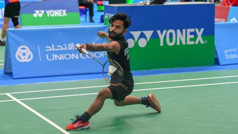 male Para badminton player Krishna Nagar plays a forehand