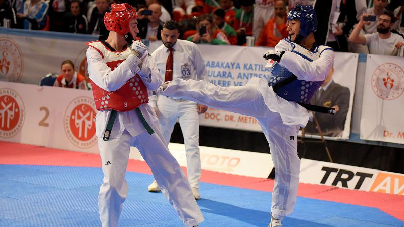 male Para taekwondo fighter Juan Diego Garcia Lopez kicks another fighter in the chest