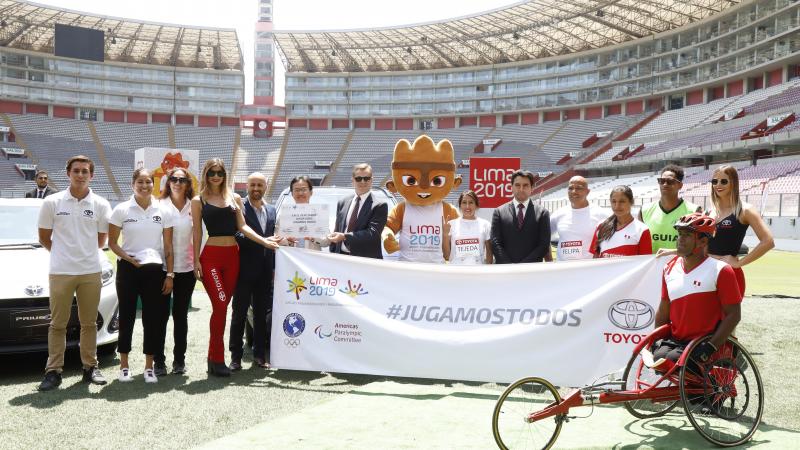 the Lima 2019 and a group of people standing in a stadium