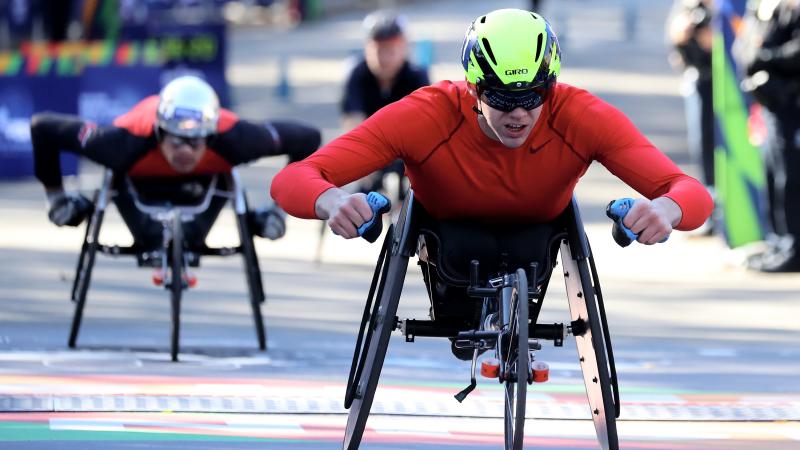 marathon racer Daniel Romanchuk crosses the finish line to win