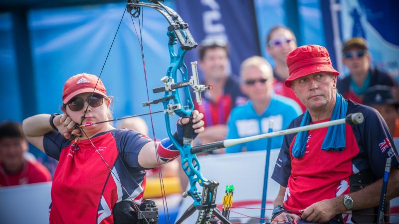 female Para archer Jessica Stretton prepares to shoot an arrow