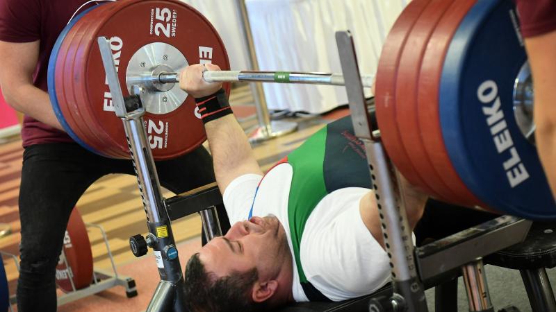 male Para powerlifter Elshan Huseynov prepares to lift the bar