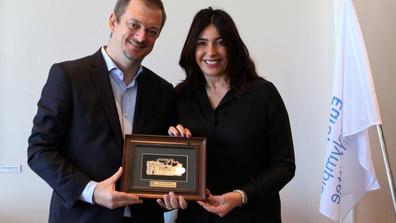 A man and a woman holding a plate