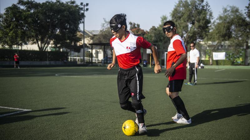 Blind football player wearing Peruvian shirt in posession of the ball