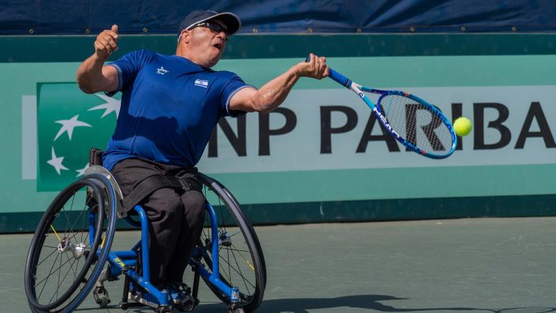 Israeli left-handed wheelchair tennis player Shraga Weinberg hits the ball during a game contested on a hard court