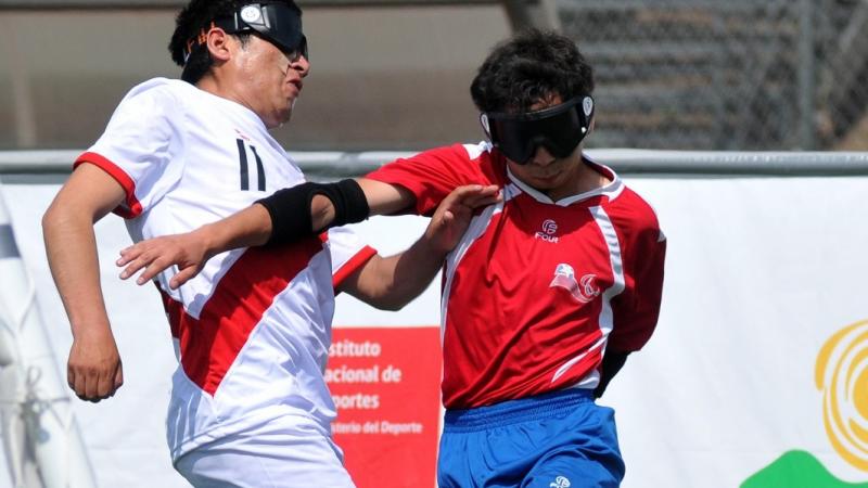 Peruvian and Chilean blind football players fight for the ball