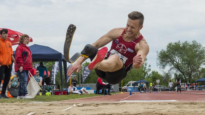 A man with a prosthetic leg competing in long jump