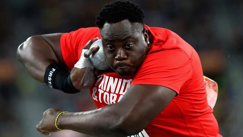 Akeem Stewart about to throw the shot while wearing a Trinidad & Tobago shirt