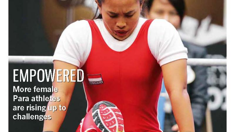 Magazine cover photo of Asian powerlifting bowing her head