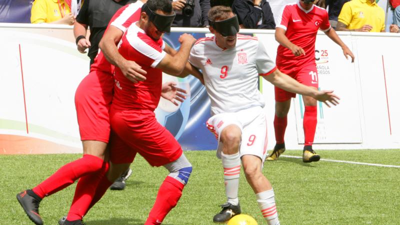 Antonio Gaitan takes the ball forward while a Russian defender tries to stop him