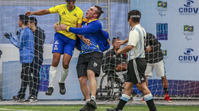 Raimundo Nonato jumps and celebrates his goal while Argentinian defender express sadness